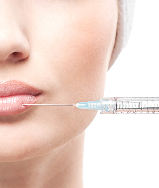 Woman getting dermal fillers on the lips