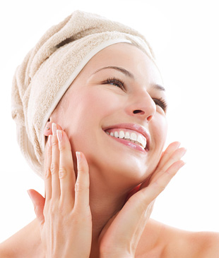 Woman smiling with towel on her head