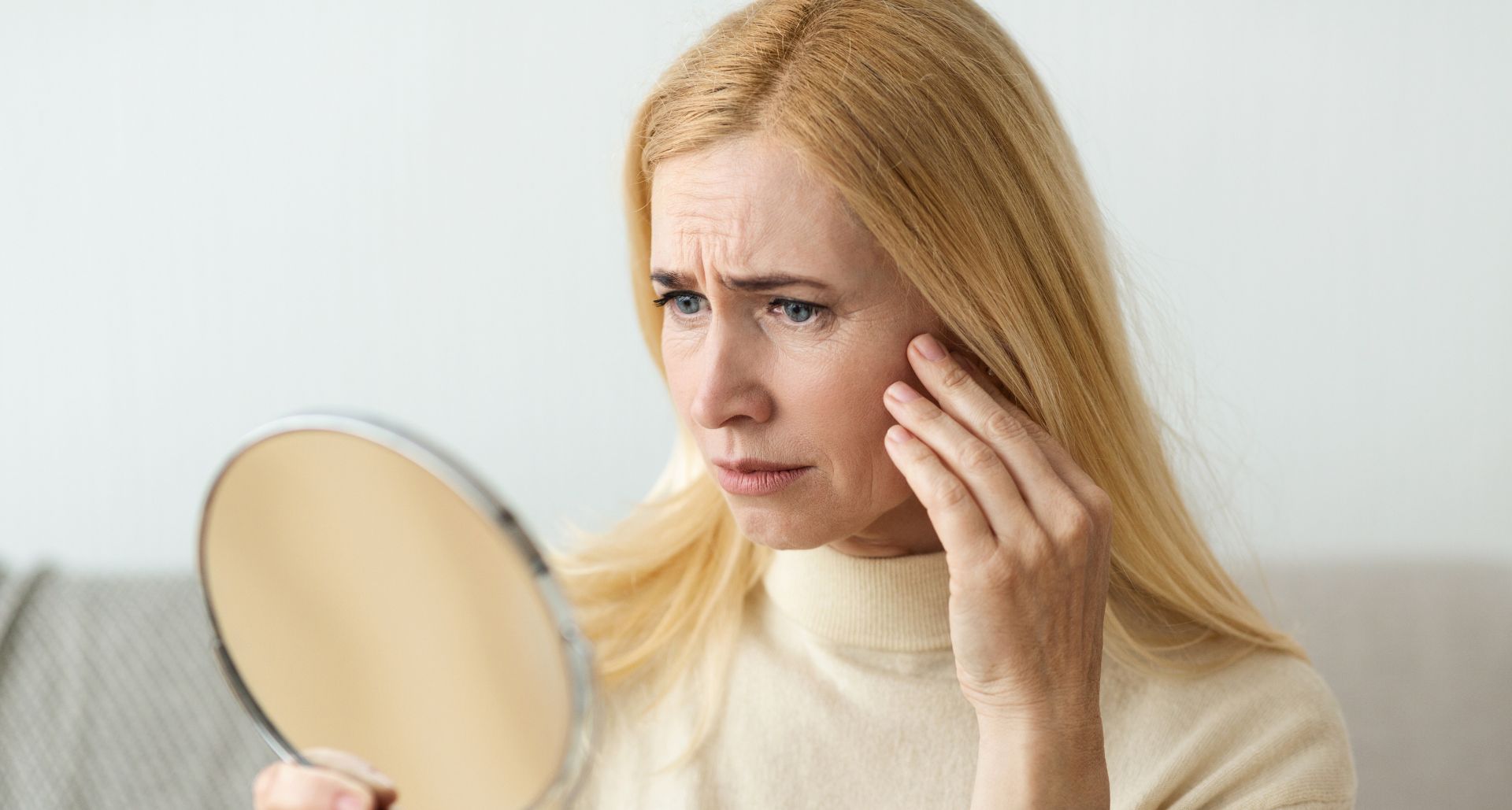 elderly woman looking in the mirror